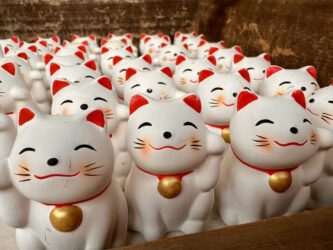 Japan, Miyajima - Daishoin Temple, a maneki-neko (beckoning cat)